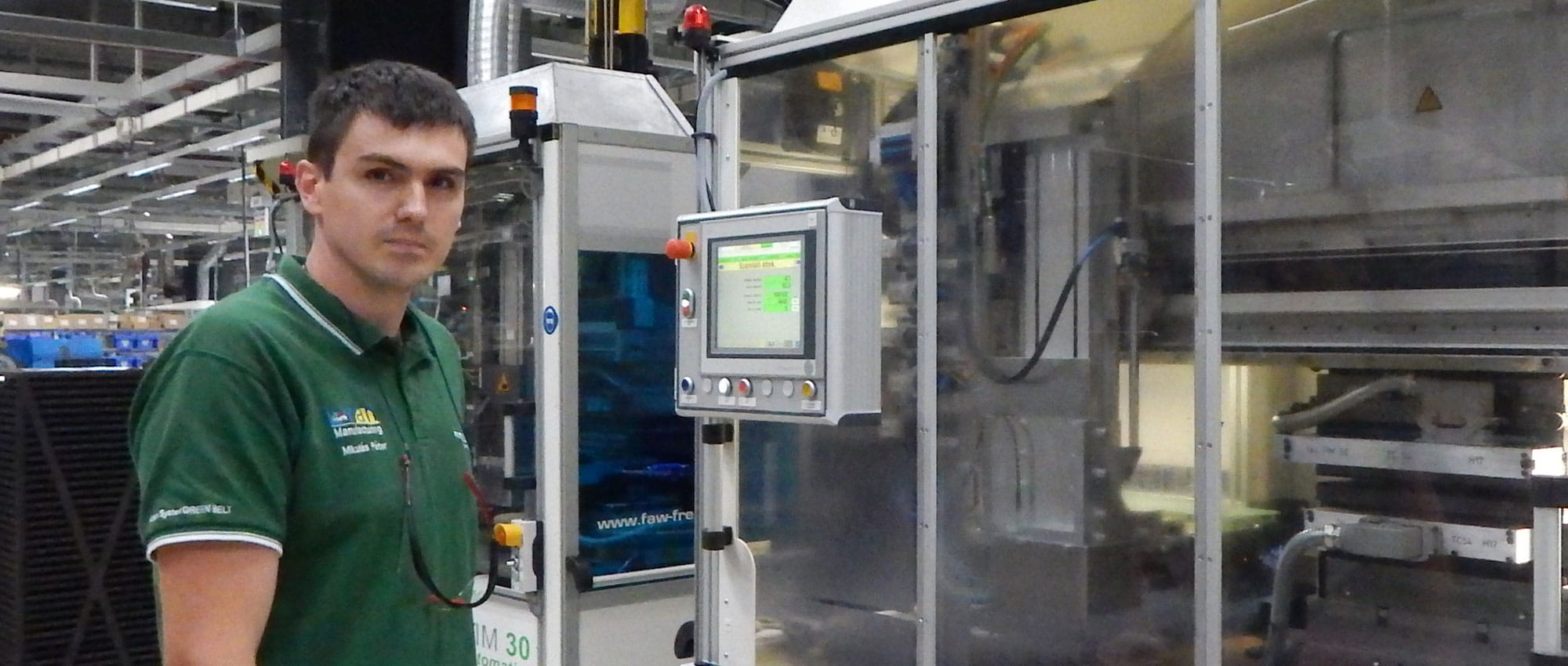 Close up shows Peter Mikulas standing in front of a machine