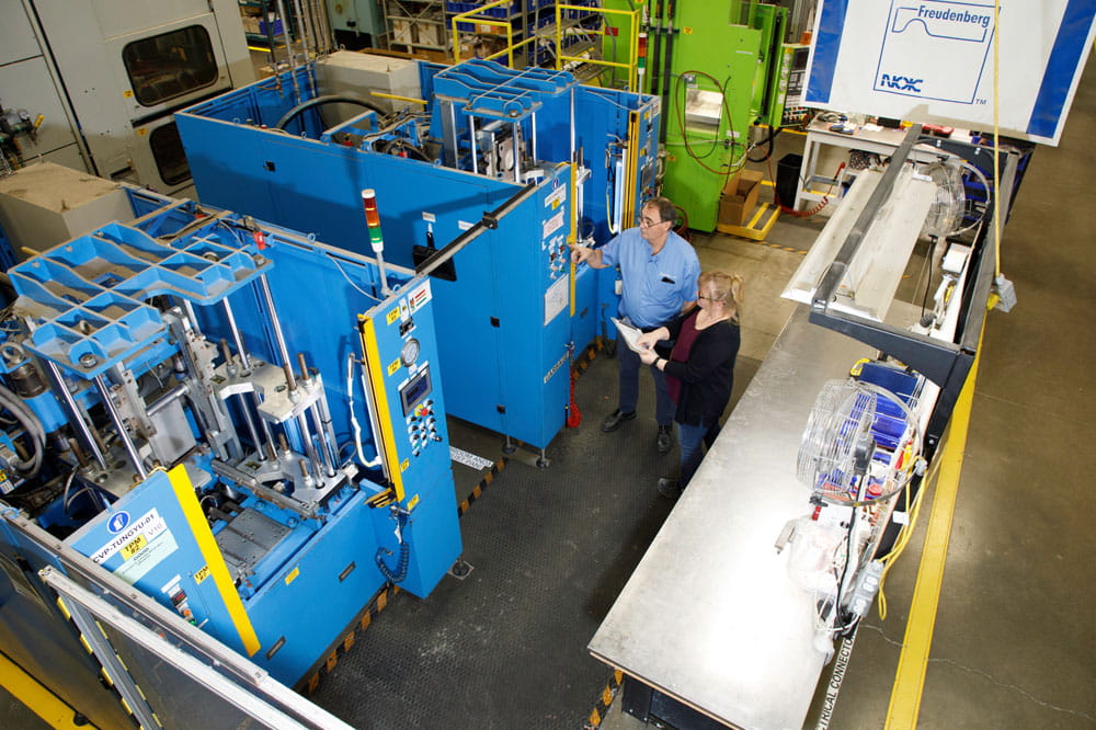 Two work colleagues are standing by one of the new Tung-Yu presses.