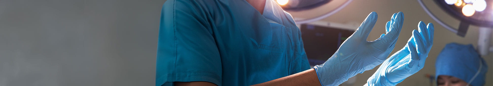 A worker wearing blue gloves to maintain cleanliness and prevent cross-contamination