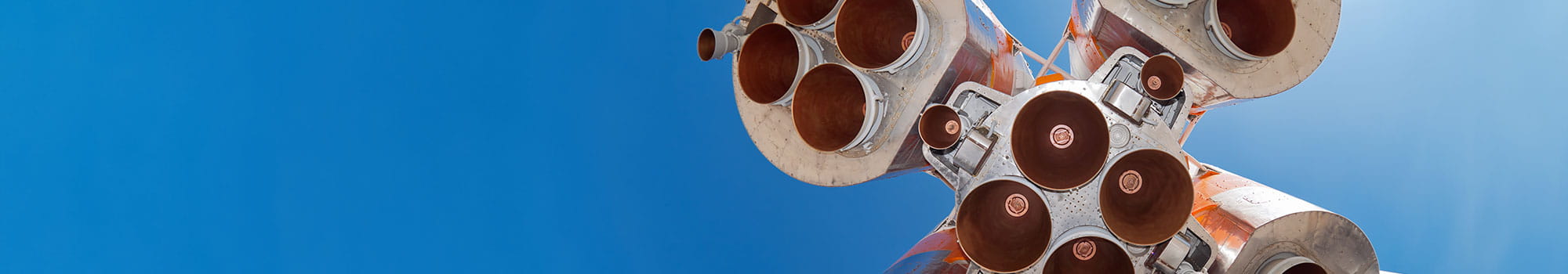 Details of space rocket engine against blue sky background