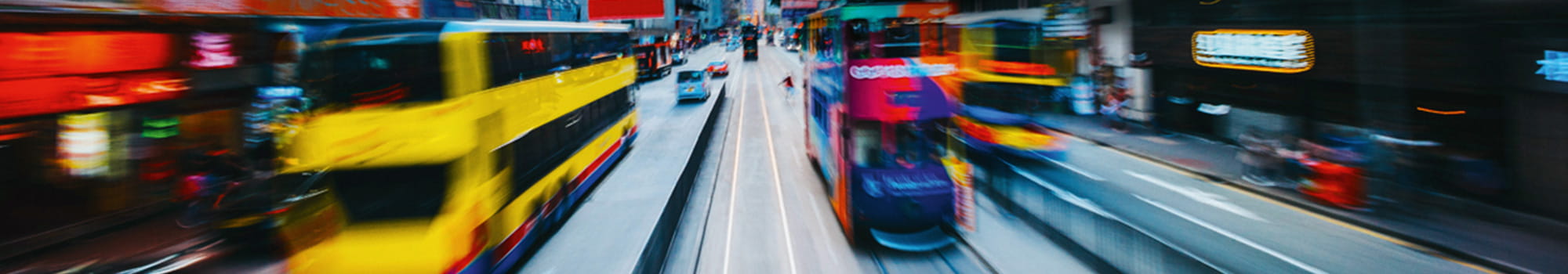 Buses and trucks in a large city at traffic lights during rush hour