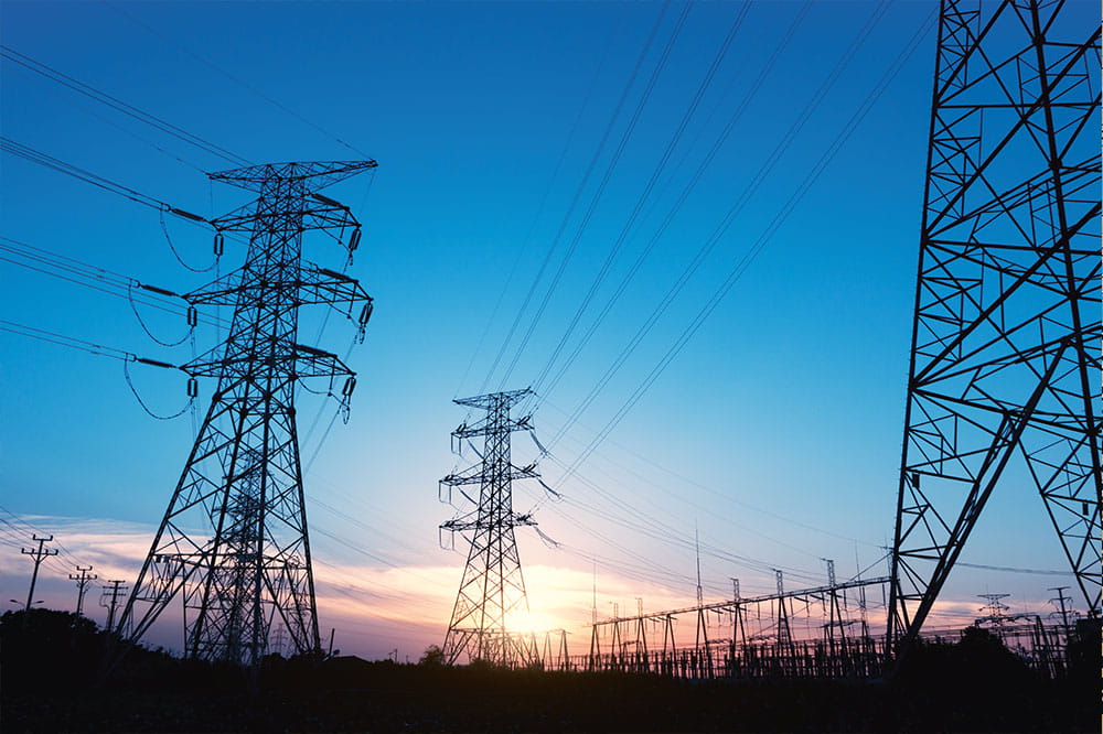 Power poles in front of a sun set. 