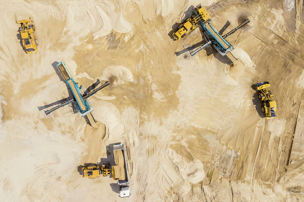 Construction vehicles mine sand