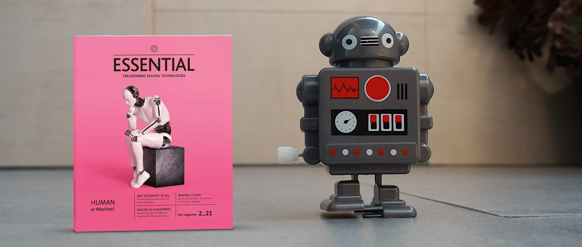 new essential magazine next to robot