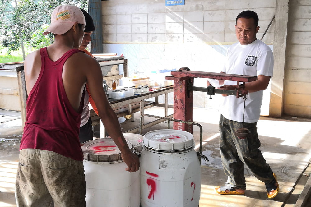 Two men making rubber.