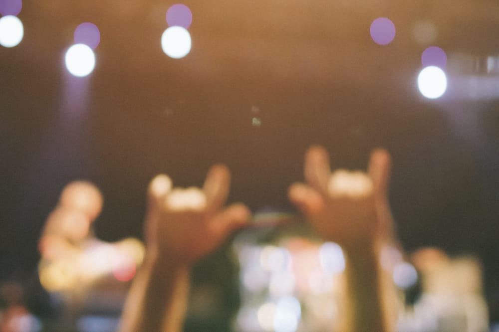 Hands in the air at a concert. Copyright: iStock: MoreISO