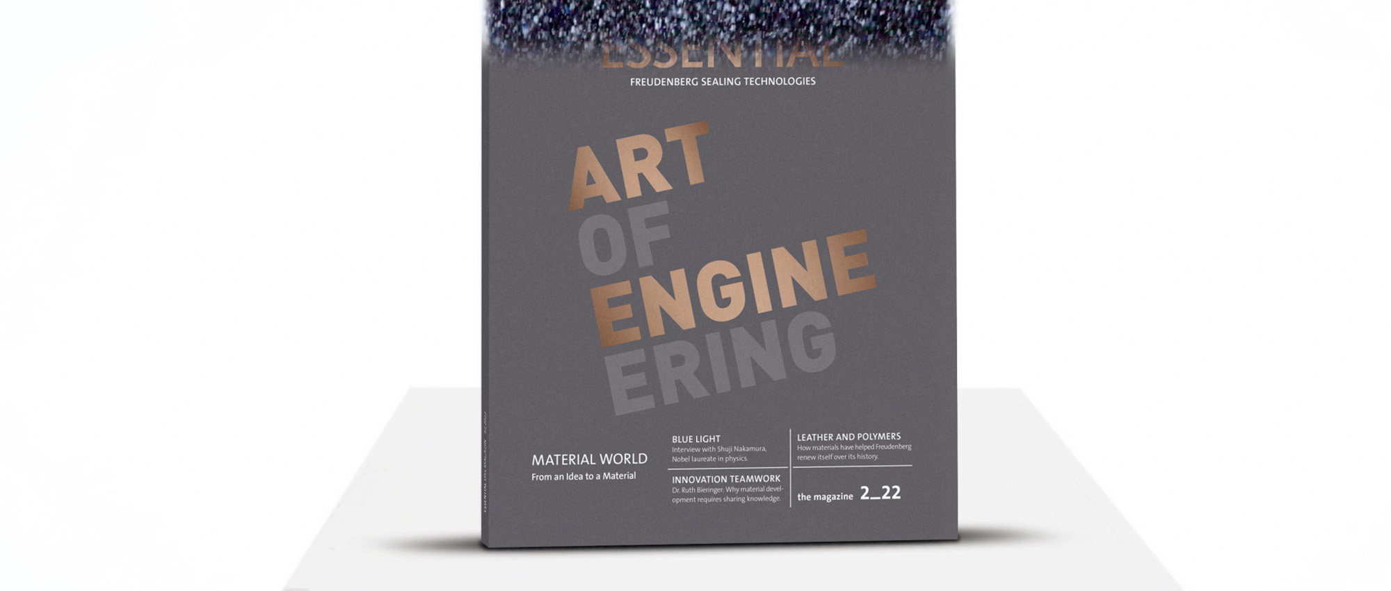 The issue of the Magazine Essential with the inscription Art of Engineering standing on a podium.