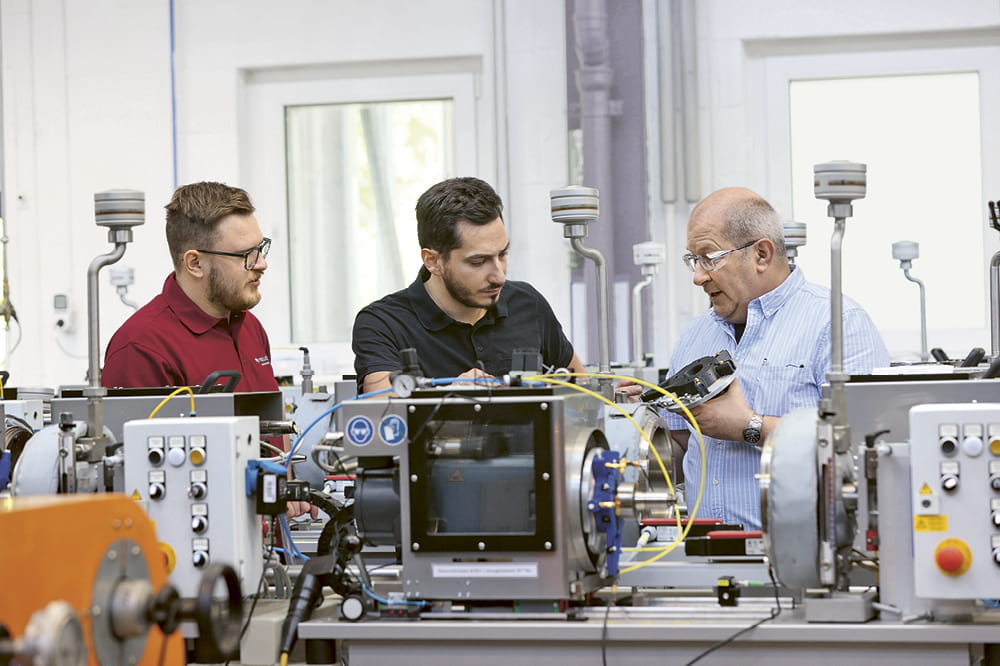 Robert Leins, Manager of the Weinheim test facility in Germany, inspects a new test stand along with two colleagues. 