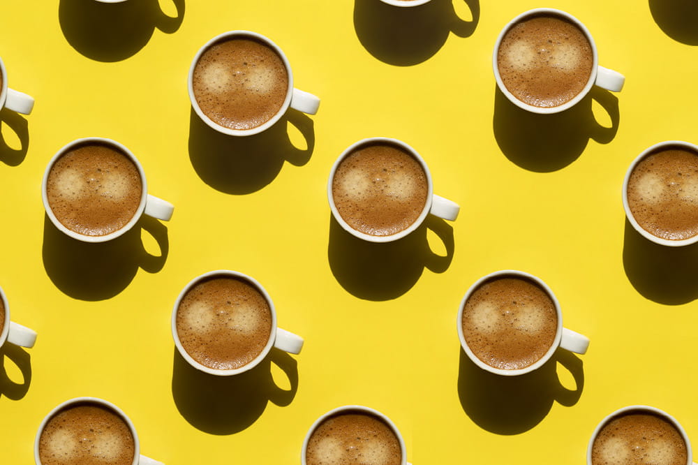 Collage of coffee cups on a yellow background.