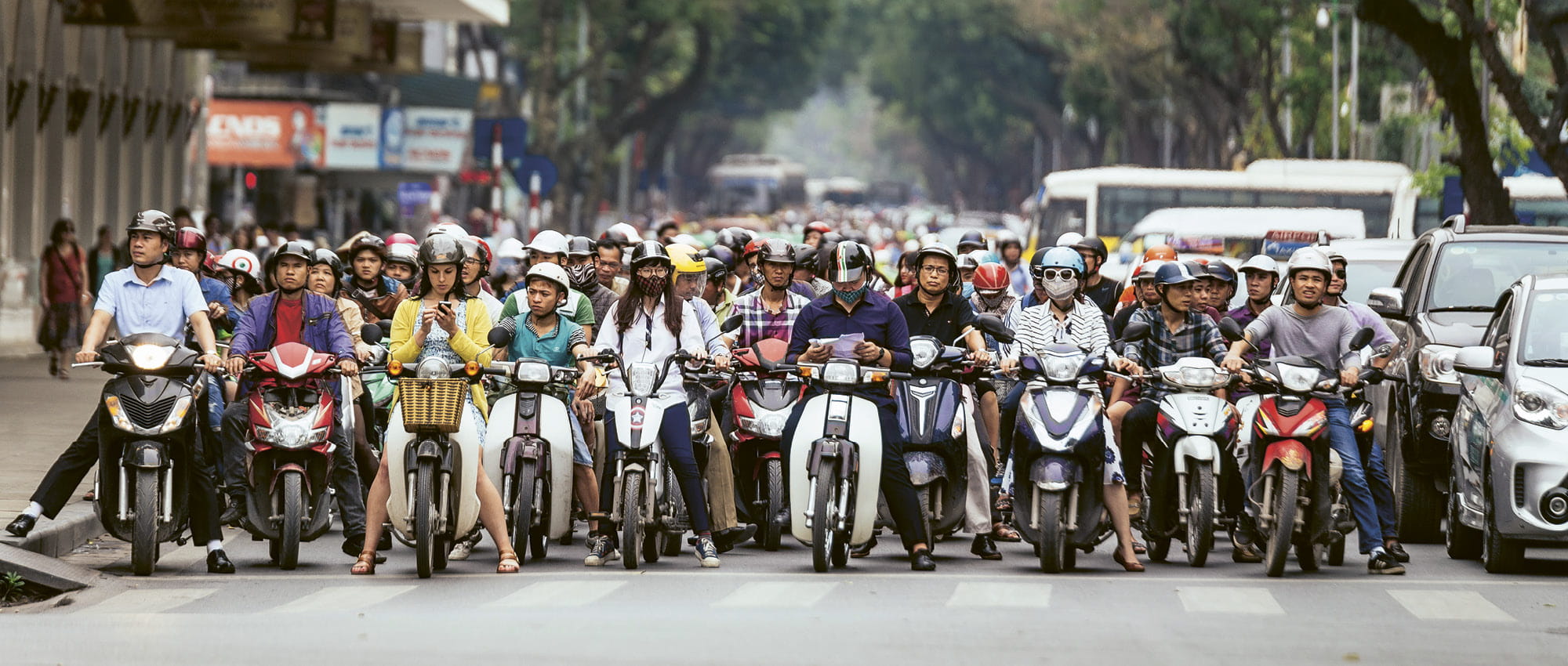 Many people on motorcycles waiting in front of a crosswalk. Copyright: iStock/Artit_Wongpradu