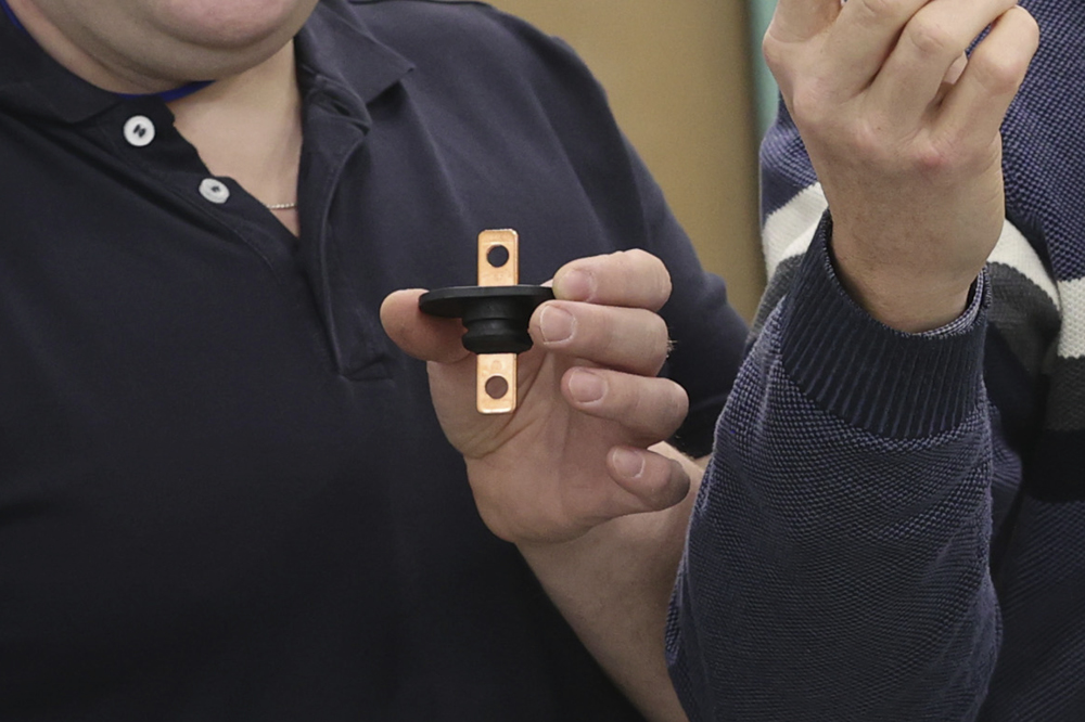 Busbar modules with an integrated seal being held into the camera. 