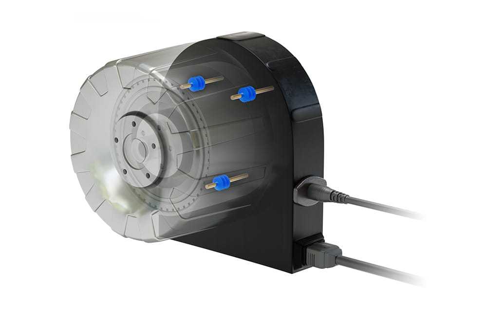 Black electronic device with transparent toothed wheel and four blue pins, connected to cables.