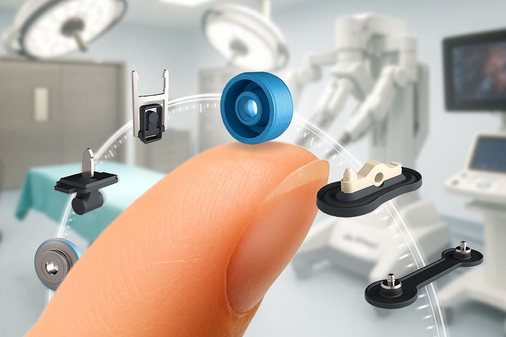 A close-up of a fingertip balancing several small micro seals, with a blurred surgical room in the background.
