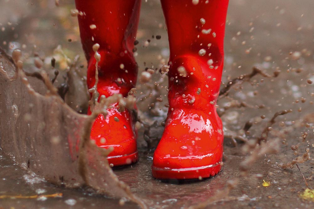 Red rubber boots in the mud
