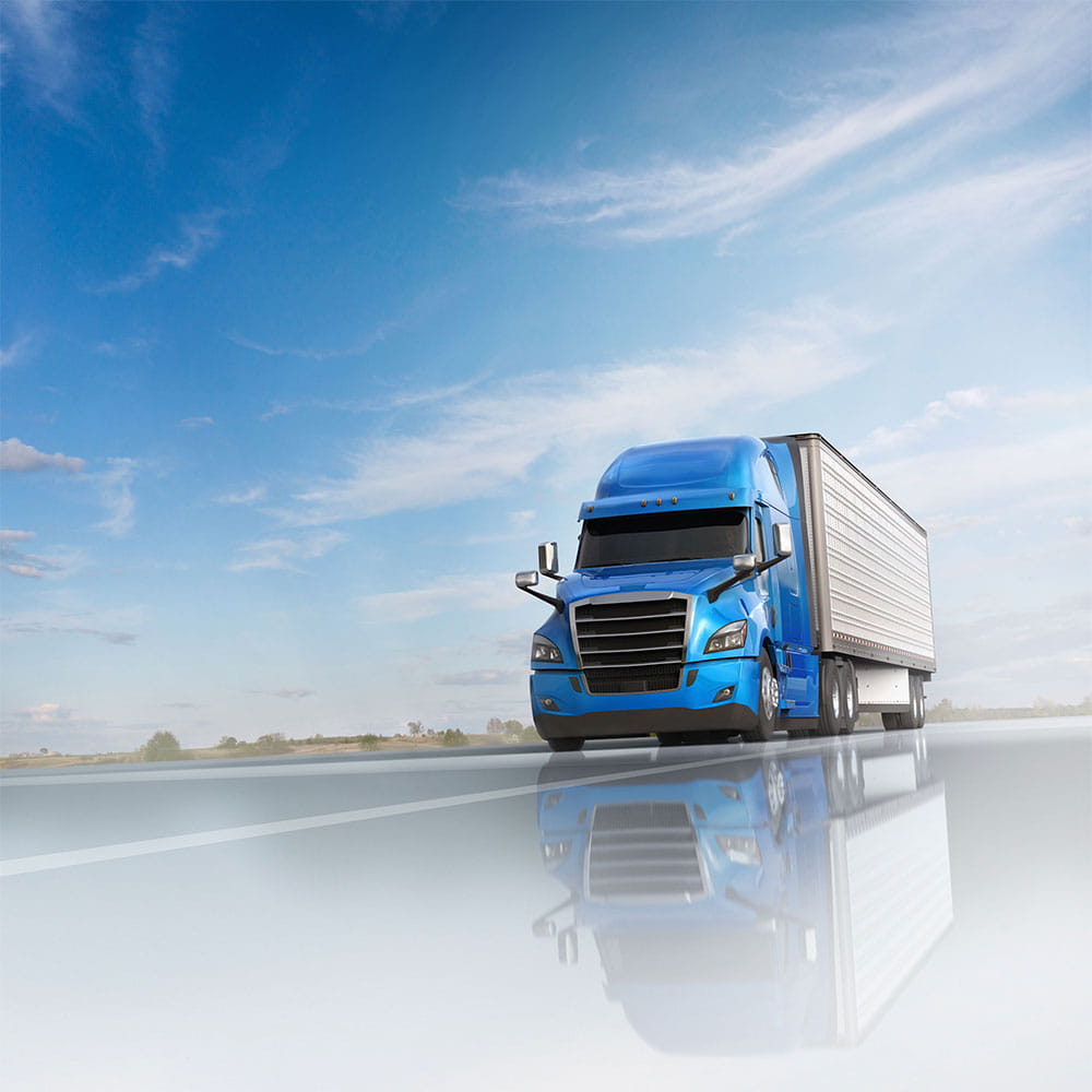 High-gloss image of a blue truck with a trailer driving on an open highway under a bright blue sky