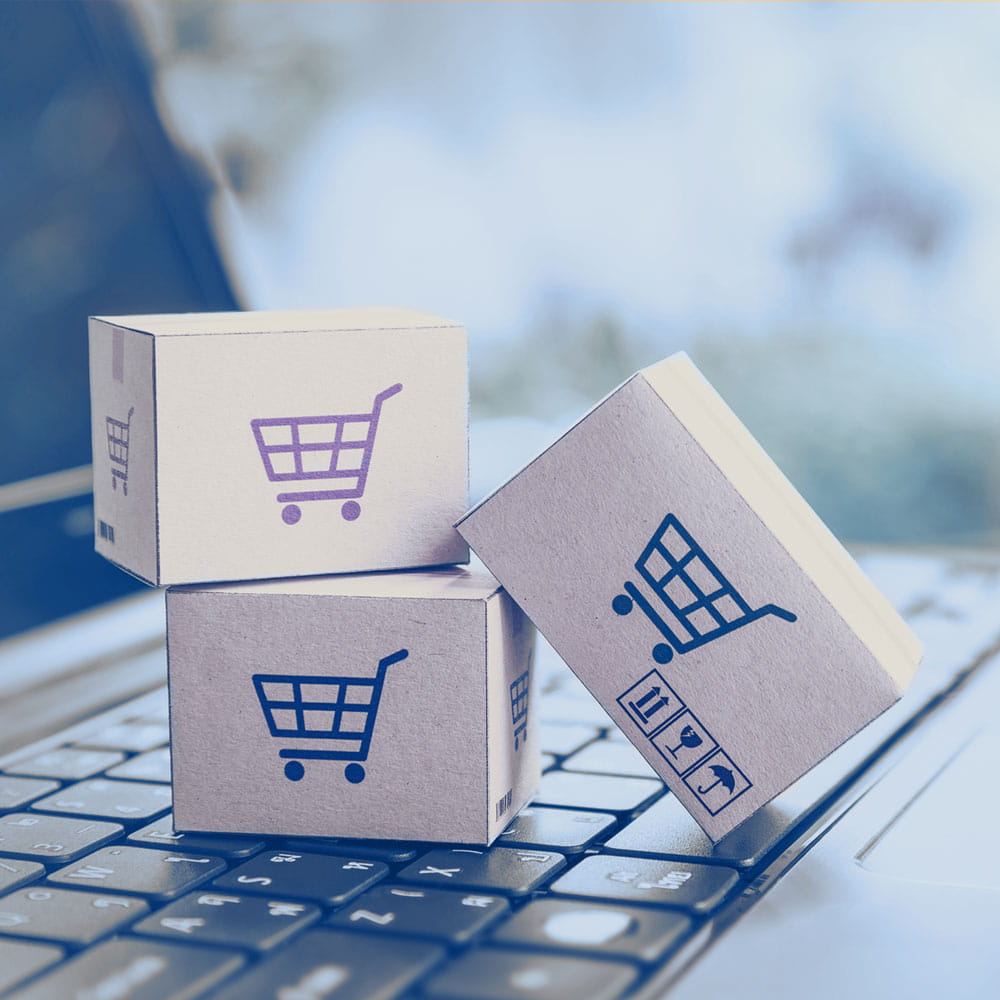 Notebook with packages on the keyboard with blue and red carts on them 