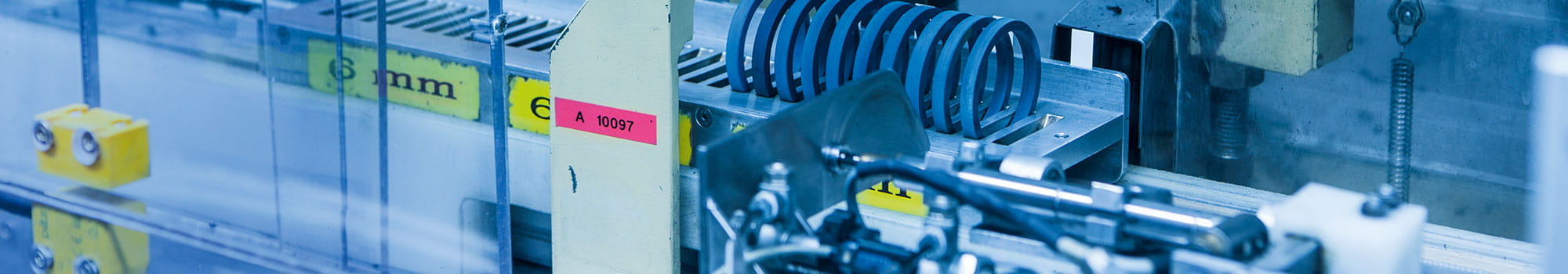 Machine in motion with blue seals on a metal tray