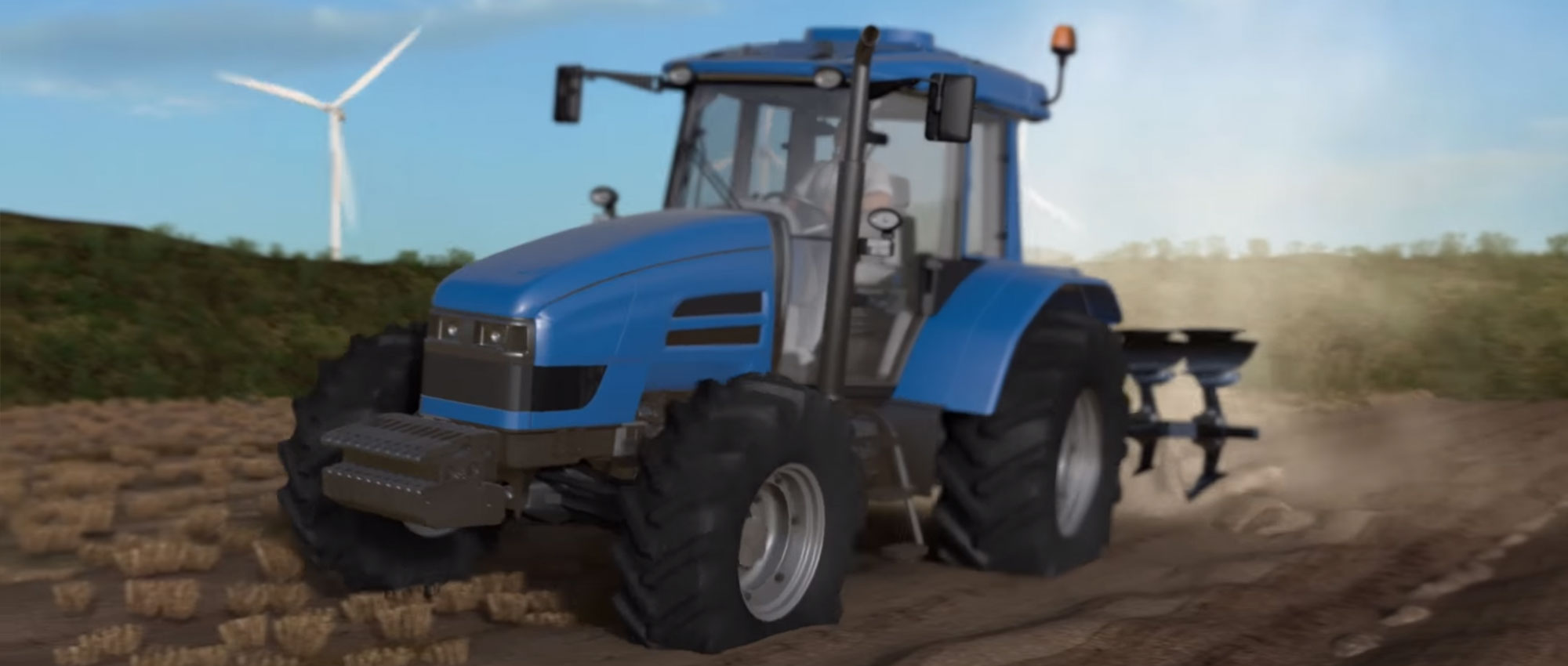 Traktor auf dem Feld und im Hintergrund sieht man ein Windkraftrad
