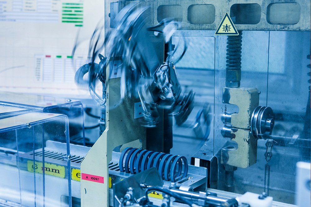 Machine in motion with blue seals on a metal tray